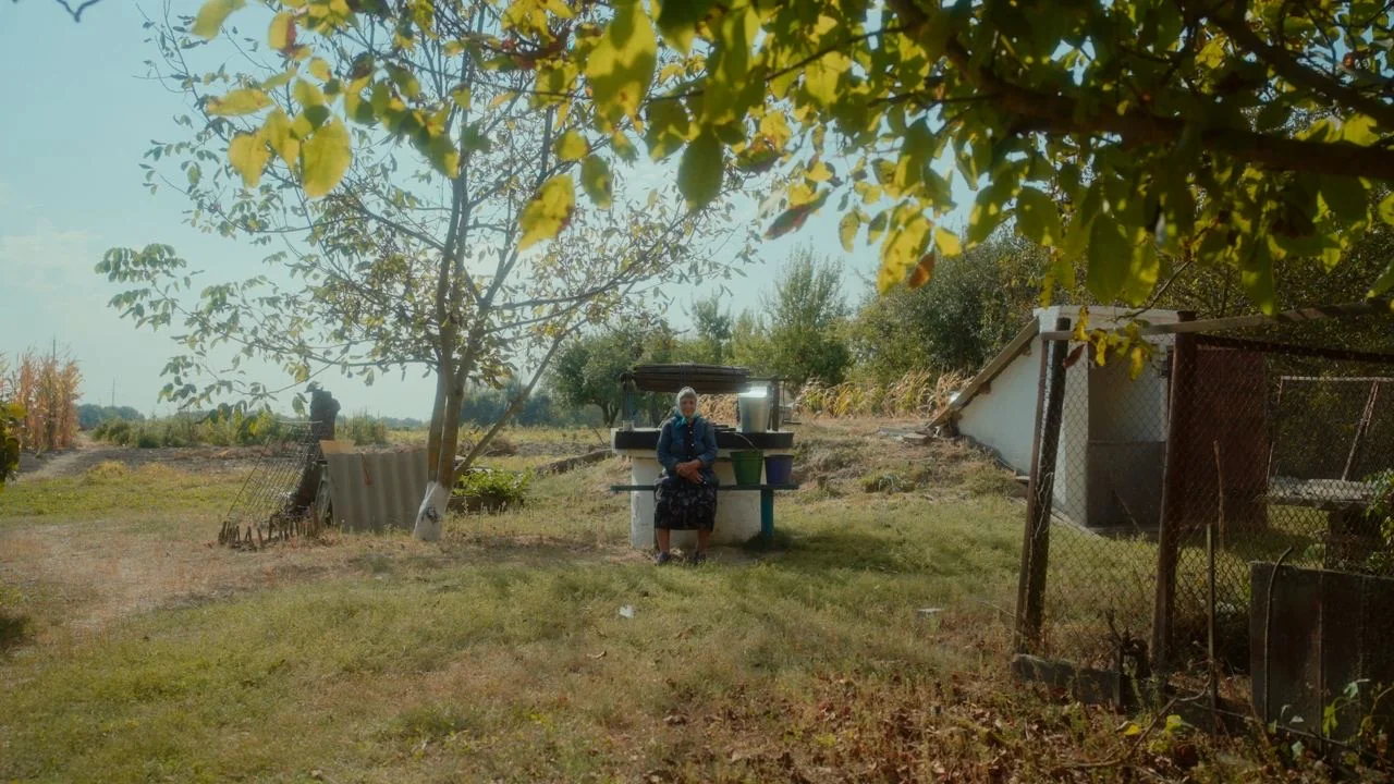 Grandma in the yard near the well